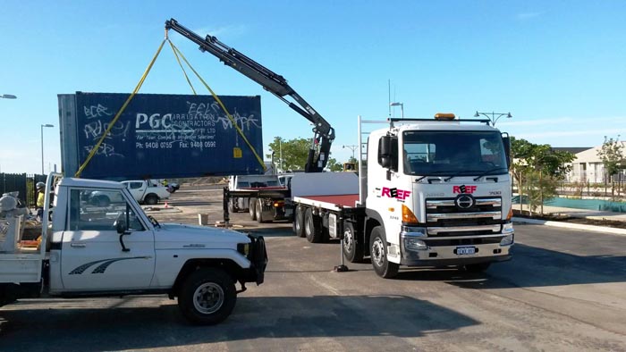 Image of the hiab crane truck delivering a sea container